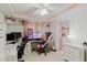 Bright office space with pink accents, equipped with dual computer setups and a ceiling fan at 5601 Golden Dr, Tampa, FL 33634