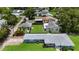 Aerial view showcasing a blue home with mature trees, well-kept lawns, and surrounding neighborhood at 5725 18Th S Ave, Gulfport, FL 33707