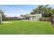 Large backyard with well kept lawn and partial fencing at 5725 18Th S Ave, Gulfport, FL 33707