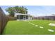Green backyard features a screened-in porch and stone path at 5725 18Th S Ave, Gulfport, FL 33707