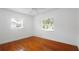 Bedroom featuring gleaming hardwood floors and natural light from the two windows at 5725 18Th S Ave, Gulfport, FL 33707