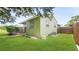 Side view of home featuring a well-manicured lawn and mature landscaping at 5725 18Th S Ave, Gulfport, FL 33707