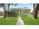 Cozy single-story home with a green exterior and well-manicured front yard at 5725 18Th S Ave, Gulfport, FL 33707