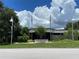 Gulfport Public Library exterior featuring a curved façade and flags at 5725 18Th S Ave, Gulfport, FL 33707