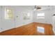 Bright living room featuring gleaming hardwood floors and a ceiling fan at 5725 18Th S Ave, Gulfport, FL 33707
