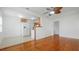 Open concept living area showcasing hardwood floors, ceiling fan, and adjoining kitchen at 5725 18Th S Ave, Gulfport, FL 33707