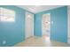Bonus room or Florida room featuring tile flooring, access to the backyard, and bright turquoise walls at 5725 18Th S Ave, Gulfport, FL 33707