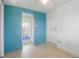 Bonus room or Florida room featuring tile flooring, access to the backyard, and bright turquoise walls at 5725 18Th S Ave, Gulfport, FL 33707
