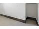 An empty room featuring a white wall, tile floor, and dark trim around the base of the wall at 5725 18Th S Ave, Gulfport, FL 33707
