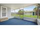 Relaxing sunroom with blue carpet, leading to a grassy backyard at 5725 18Th S Ave, Gulfport, FL 33707