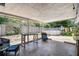 View of the shaded back patio featuring an above-ground pool and outdoor seating at 6200 13Th Ave, New Port Richey, FL 34653