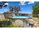 Backyard with above-ground swimming pool, fence, and home exterior at 6200 13Th Ave, New Port Richey, FL 34653