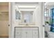 Well-lit bathroom features vanity with cabinets and drawers, and a large mirror at 6200 13Th Ave, New Port Richey, FL 34653
