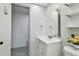 Bathroom featuring a vanity, toilet, and a mirror with a decorative light fixture at 6200 13Th Ave, New Port Richey, FL 34653