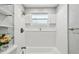 Bathroom boasting a tub with a showerhead, and niche shelving at 6200 13Th Ave, New Port Richey, FL 34653