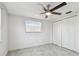 Bedroom with ceiling fan, closet, a light neutral paint scheme, and window at 6200 13Th Ave, New Port Richey, FL 34653