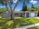 Attractive one-story house with stone accents, mature trees, and a lush green lawn at 6200 13Th Ave, New Port Richey, FL 34653