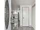 Foyer view showcases the home's interior with tile flooring, a kitchen with white cabinets, and stainless-steel appliances at 6200 13Th Ave, New Port Richey, FL 34653
