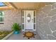 Inviting front entrance features a decorative glass door with sidelights and a charming welcome mat on a covered porch at 6200 13Th Ave, New Port Richey, FL 34653