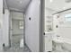 Hallway leading into a bathroom with a shower, toilet, and vanity at 6200 13Th Ave, New Port Richey, FL 34653
