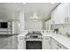 Bright kitchen features stainless steel oven, marble countertops, white cabinets, and backsplash at 6200 13Th Ave, New Port Richey, FL 34653