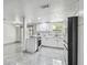 Modern kitchen is equipped with white cabinetry, sleek countertops, and stainless steel appliances for a contemporary feel at 6200 13Th Ave, New Port Richey, FL 34653