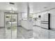 Open kitchen and dining area features stainless steel appliances and sliding door to outdoor space at 6200 13Th Ave, New Port Richey, FL 34653