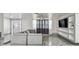 Spacious living room with marble floors, comfortable sectional couch, and stylish built-in shelving at 6200 13Th Ave, New Port Richey, FL 34653