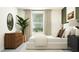 Well-lit bedroom with a queen bed, black nightstands, modern decor, and a tranquil atmosphere at 6611 Active Run, New Port Richey, FL 34653