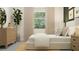 Serene bedroom features a comfortable queen bed, green accent wall, dresser, and neutral-toned furnishings at 6611 Active Run, New Port Richey, FL 34653