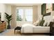 Comfortable bedroom with a large window, bedside table, and coordinating decor at 6611 Active Run, New Port Richey, FL 34653