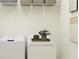 Functional laundry room with washer, dryer, and overhead shelving at 6611 Active Run, New Port Richey, FL 34653