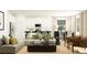 Bright open-concept living room featuring a sofa, modern chairs, and adjacent eat-in kitchen at 6611 Active Run, New Port Richey, FL 34653