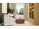 Bright living room features stylish seating, a textured round coffee table, and a built-in bookshelf at 6611 Active Run, New Port Richey, FL 34653