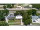 Aerial view of a neighborhood with a pool, and a school in the distance at 706 E Gate Dr, Safety Harbor, FL 34695