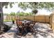 Cozy backyard deck, perfect for outdoor dining, featuring a table with four chairs under a shade tree at 706 E Gate Dr, Safety Harbor, FL 34695