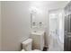 Bathroom with white vanity, framed mirror, and modern light fixture at 706 E Gate Dr, Safety Harbor, FL 34695