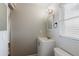 Bathroom with white vanity, framed mirror, and modern light fixture at 706 E Gate Dr, Safety Harbor, FL 34695