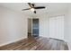 Bedroom featuring updated flooring, ceiling fan, closet, and access to other rooms at 706 E Gate Dr, Safety Harbor, FL 34695