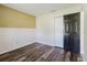Bedroom featuring wood floors, wainscoting, and a large closet at 706 E Gate Dr, Safety Harbor, FL 34695