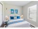 Bright bedroom with nautical artwork, white furnishings, and ample natural light at 706 E Gate Dr, Safety Harbor, FL 34695