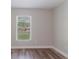 Bright bedroom features wood floors and a window with natural light at 706 E Gate Dr, Safety Harbor, FL 34695