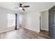 Spacious bedroom featuring updated flooring, a ceiling fan, and natural light from the window at 706 E Gate Dr, Safety Harbor, FL 34695