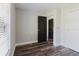 Bedroom with wood floors, a closet, and contrasting dark interior doors at 706 E Gate Dr, Safety Harbor, FL 34695