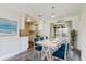 Open concept dining area with modern table, stylish blue chairs, and sliding glass doors at 706 E Gate Dr, Safety Harbor, FL 34695