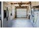Clean and functional garage with concrete floor, modern door, and utilities neatly organized at 706 E Gate Dr, Safety Harbor, FL 34695