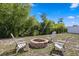 Backyard fire pit with outdoor seating and fenced perimeter at 8636 Prairie Creek Dr, New Port Richey, FL 34655
