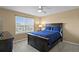 Cozy bedroom with neutral walls, plush carpeting, and a ceiling fan at 8636 Prairie Creek Dr, New Port Richey, FL 34655
