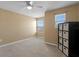 Inviting bedroom with neutral walls, carpet, a ceiling fan, and a shelf with storage bins at 8636 Prairie Creek Dr, New Port Richey, FL 34655