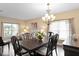 Dining room featuring a dark wood table, matching chairs, and ample natural light from the windows at 8636 Prairie Creek Dr, New Port Richey, FL 34655